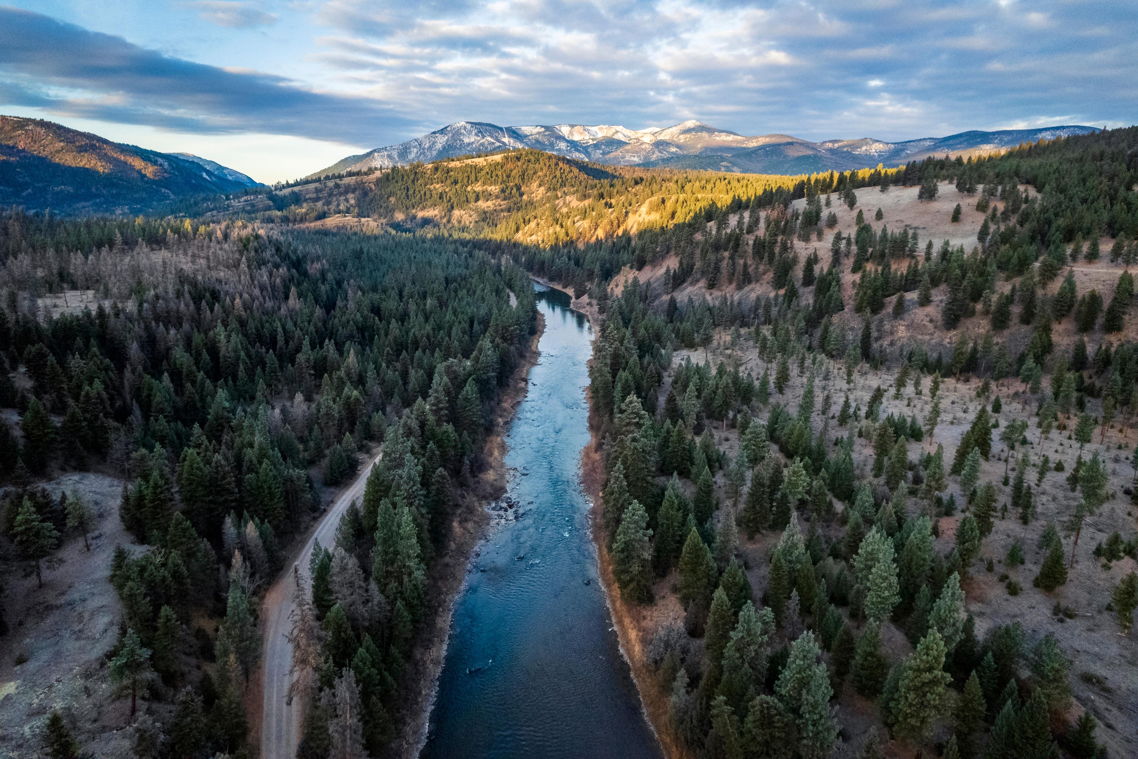 An aerial view of the Blackfoot River and surrounding forest