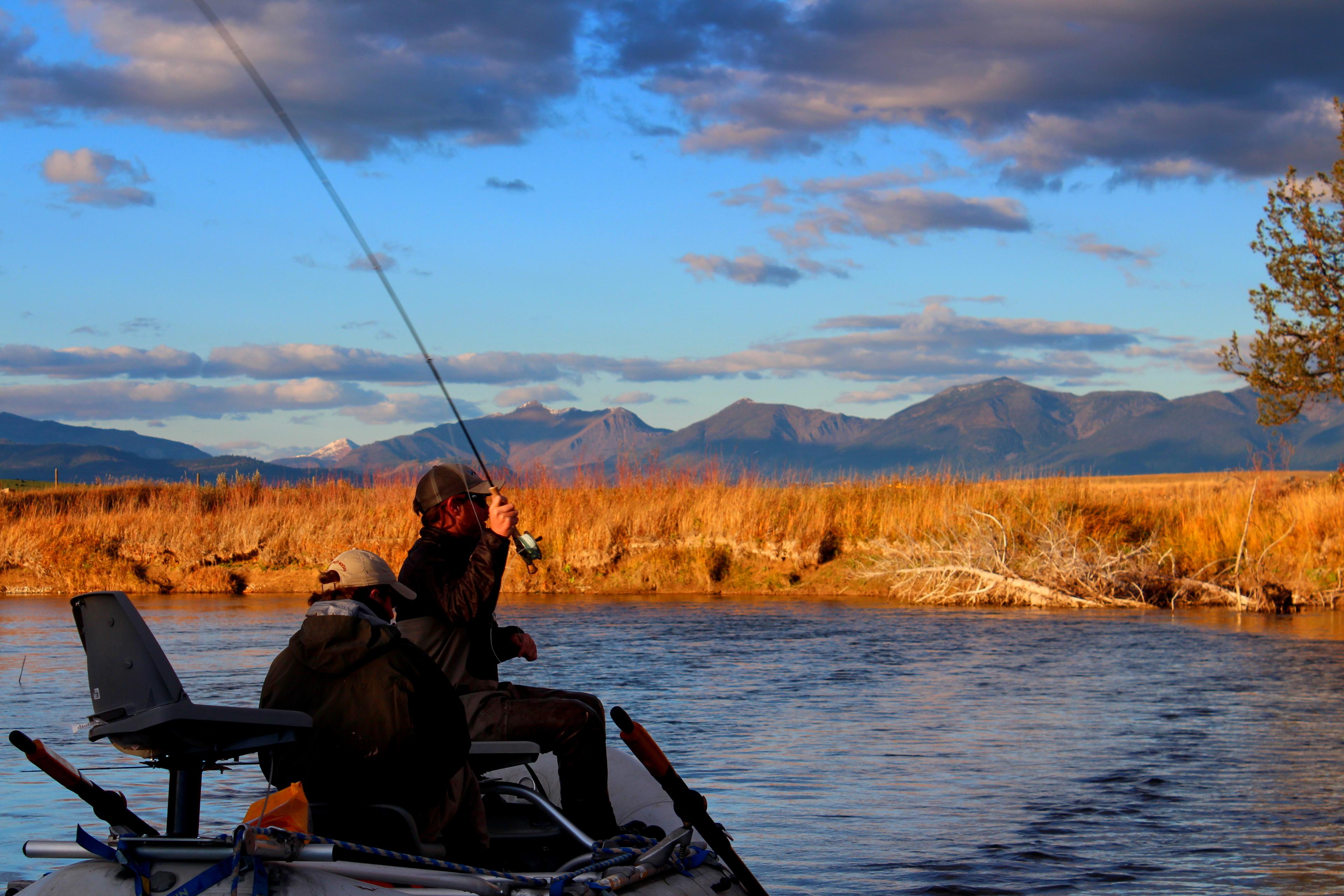Anglers fishing the Blackfoot River with mountains beyond